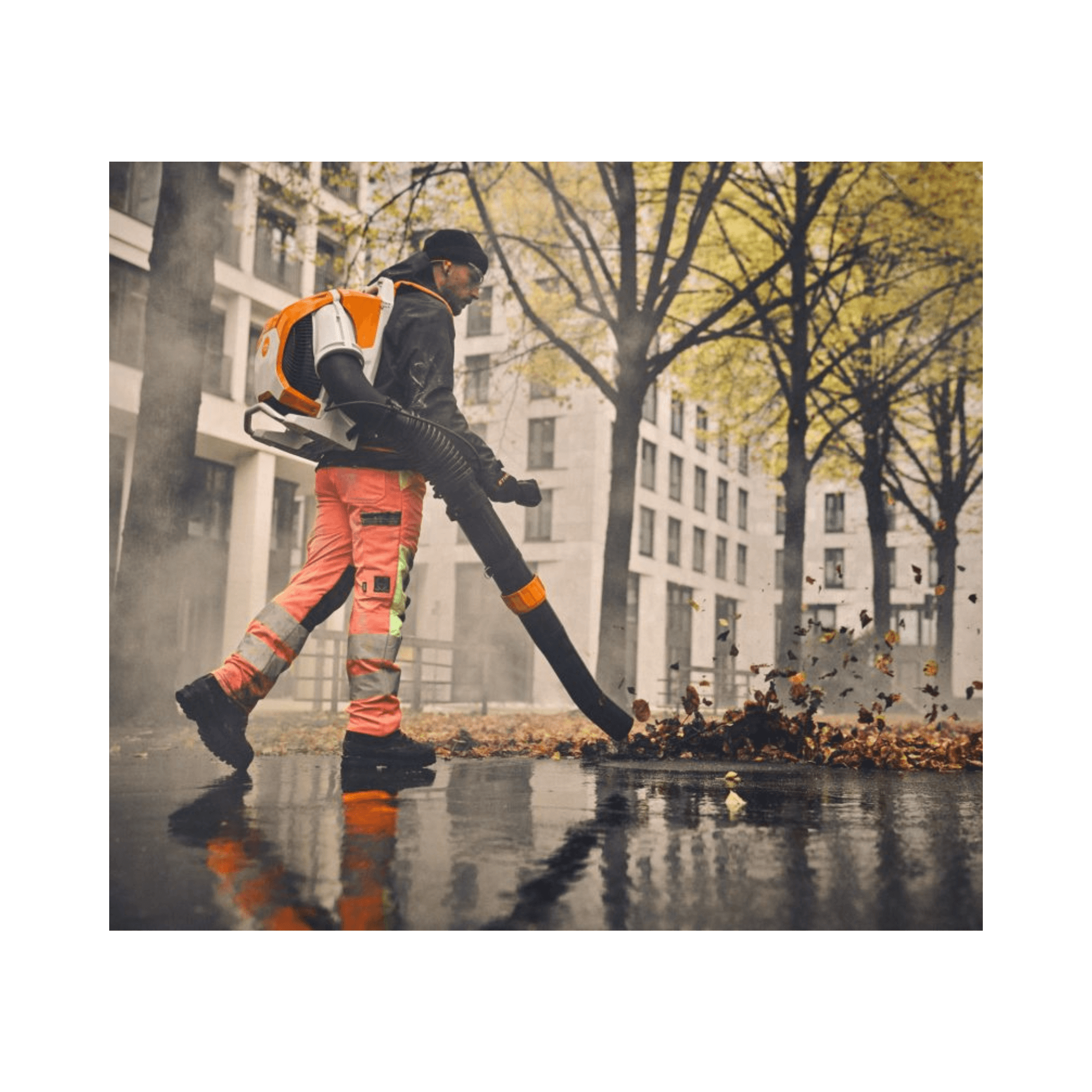 Person using BRA 600 Cordless Backpack Leaf Blower to clear leaves in an urban environment.