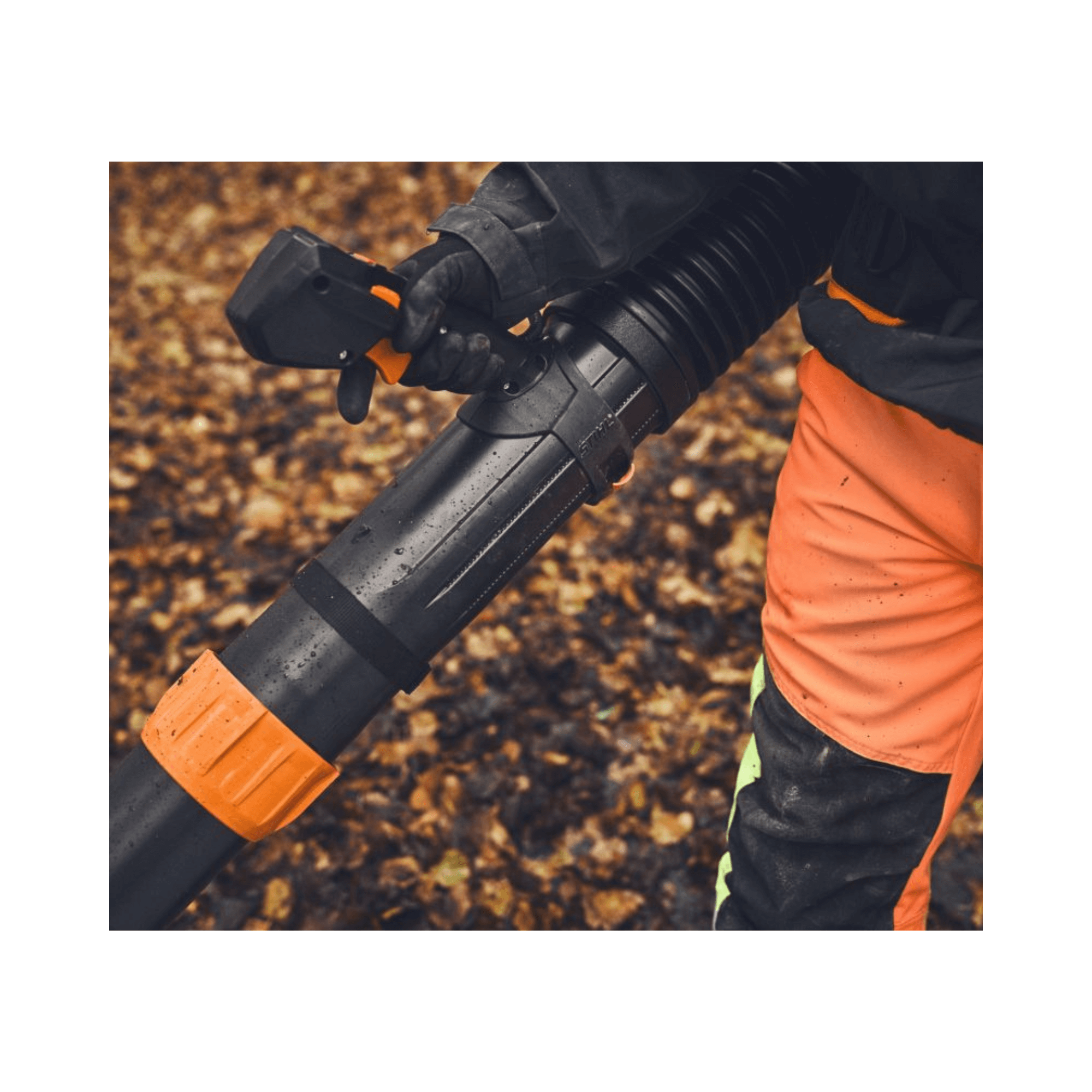 Person using the BRA 600 Cordless Backpack Leaf Blower on a bed of fallen leaves.