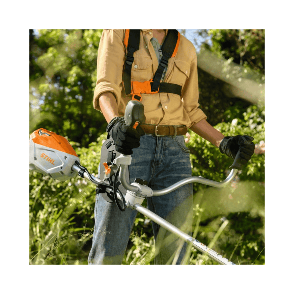 Person using the FSA 80 Cordless Trimmer in a garden setting.