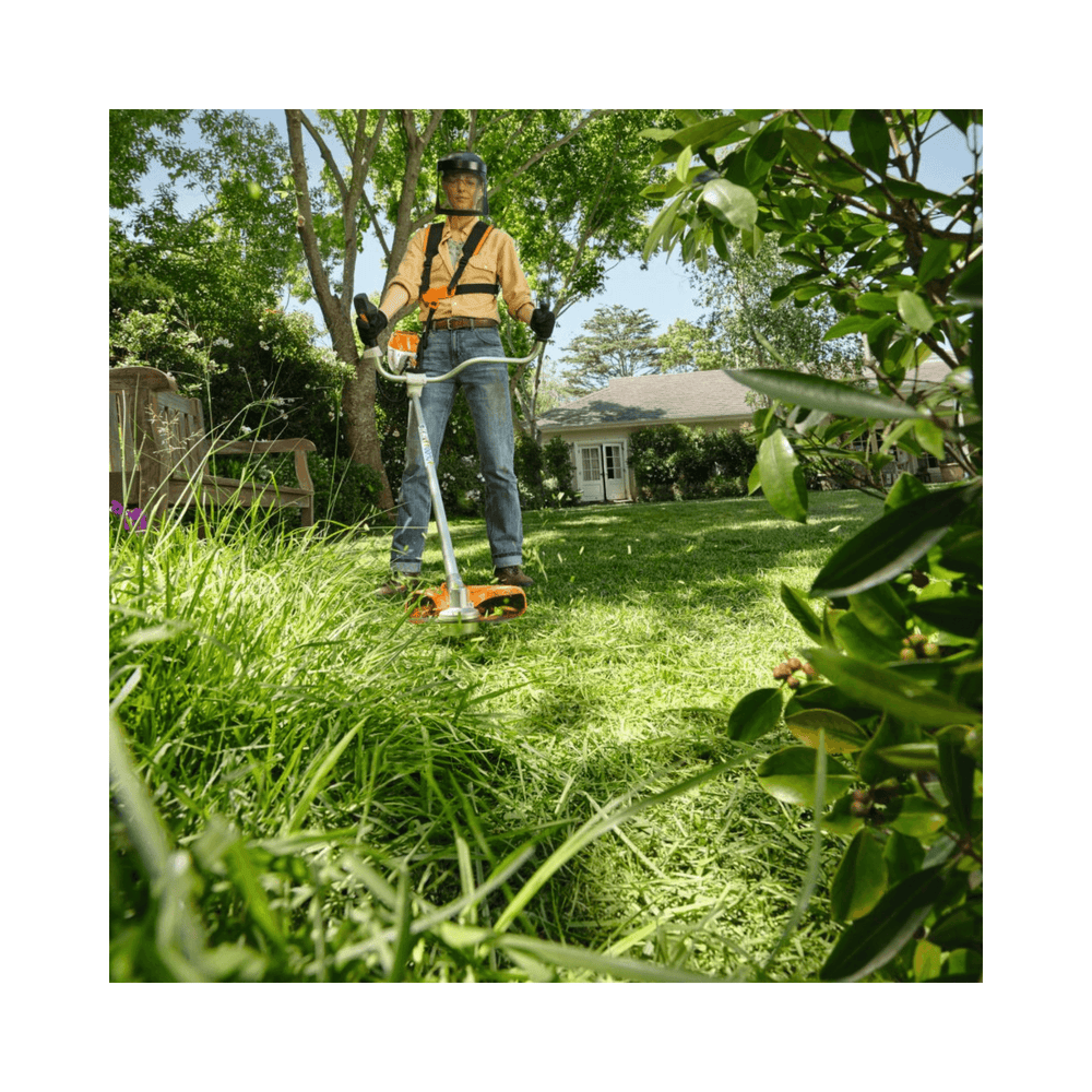 FSA 80 Cordless Trimmer being used for grass trimming in a residential garden.