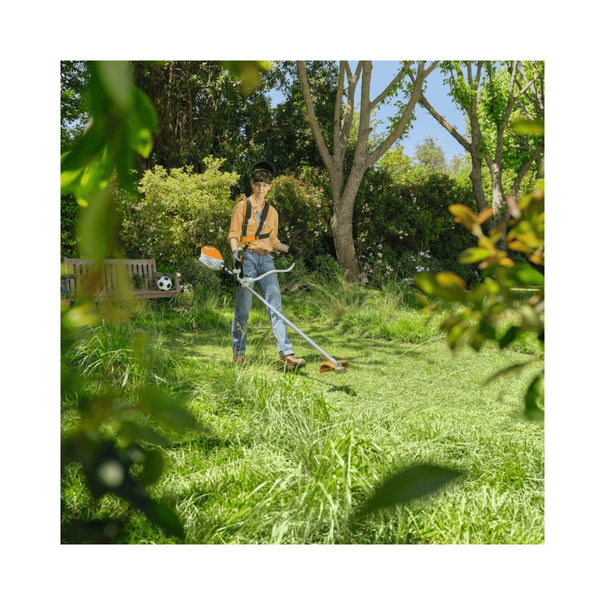 A person using the FSA 80 Cordless Trimmer to maintain a lush green garden.
