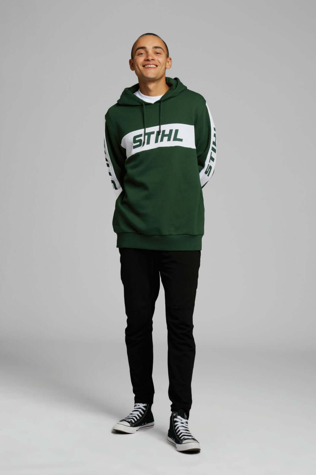 Model wearing STIHL Green Colorblock Hoodie, featuring retro design and bold logos, perfect for tree surgeons.