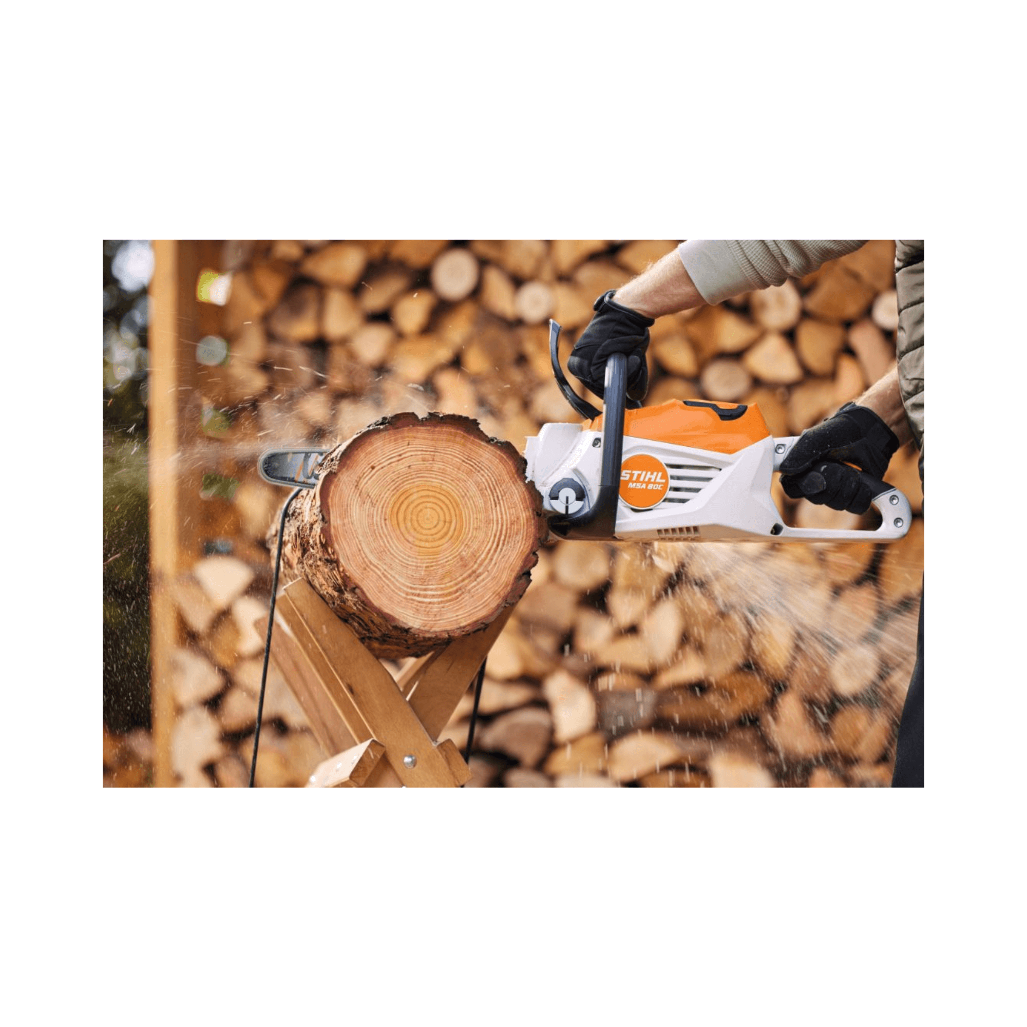 STIHL MSA 80 C-B cordless chainsaw cutting through a log, showcasing its powerful performance for tree surgeons.