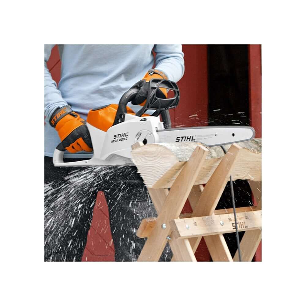 STIHL MSA 200 C-B Cordless Chainsaw cutting wood on a workbench, ideal for tree surgeons and woodworking tasks.