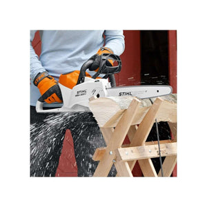 STIHL MSA 200 C-B Cordless Chainsaw cutting wood on a workbench, ideal for tree surgeons and woodworking tasks.