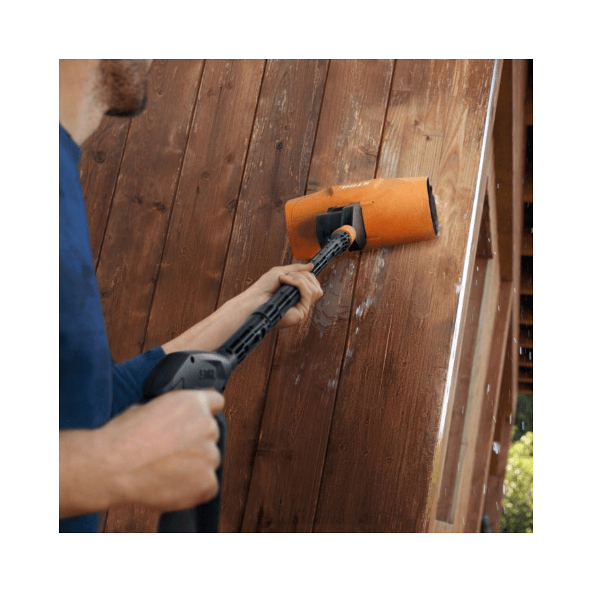 Person using RE Pressure Washer Rotating Roller Brush on wooden surface to clean and rejuvenate delicate materials.