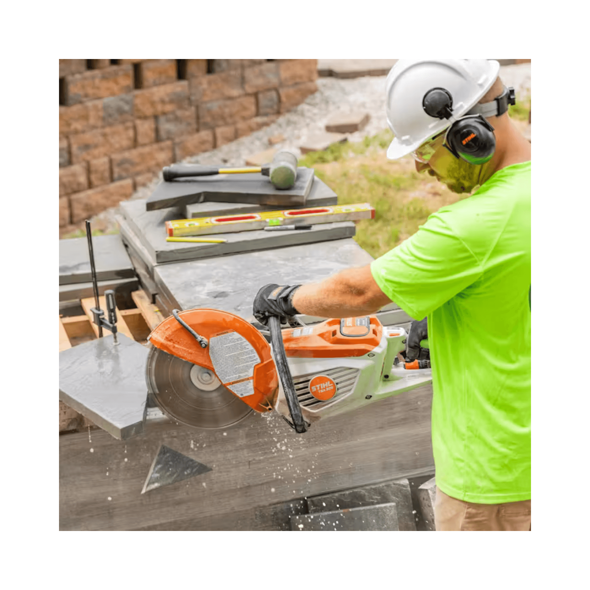 Person using a circular saw on a construction site with tools and materials around.
