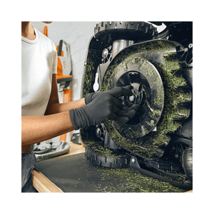 Person maintaining a robotic mower, showcasing STIHL iMOW DURO PLUS blades for enhanced lawn care.