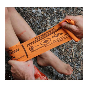 Applying SWAT-T Rescue Orange Tourniquet to a wounded leg for emergency medical treatment.