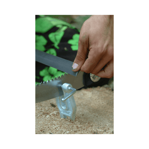 Person sharpening a Silky saw with a Feather Edge File on wood, demonstrating precise tool maintenance.
