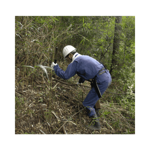 Tree surgeon using NATA Double Edge Machete in forestry work among dense foliage.