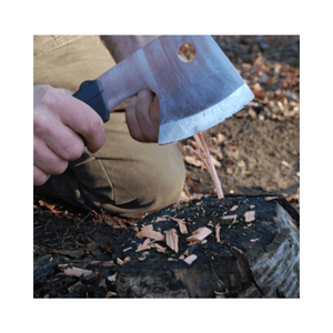 Close-up of a person using the Ono 120 Axe for precise chopping on a log, showcasing controlled outdoor skills.