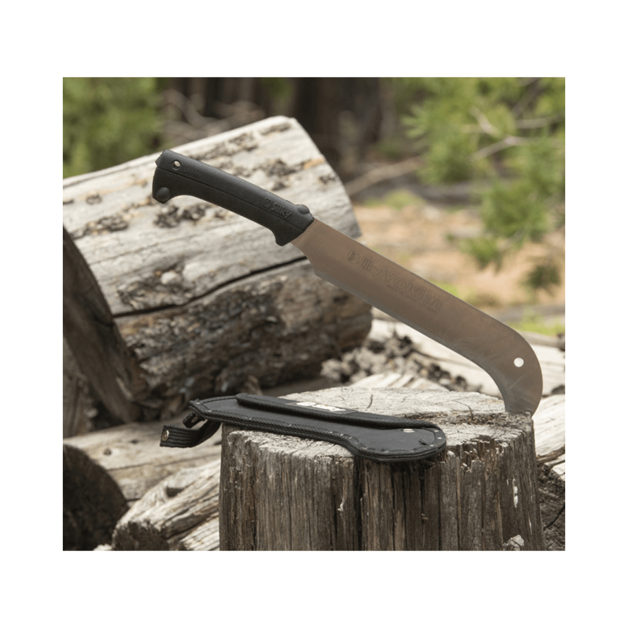 Yoki 270 Billhook resting on logs, showcasing its durable blade and handle, ideal for tree surgeons and woodland management.