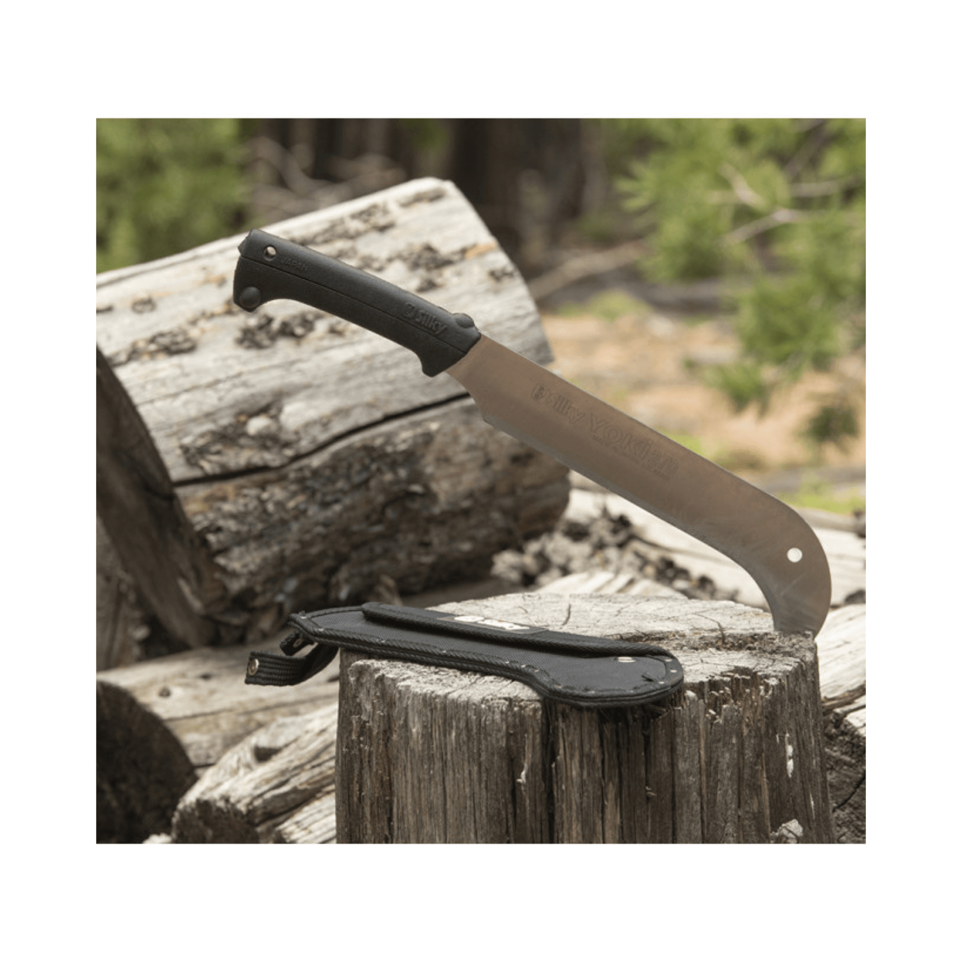 Yoki 270 Billhook resting on logs, showcasing its durable blade and handle, ideal for tree surgeons and woodland management.