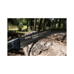 Silky Zubat Ultimate Pruning Saw 330mm blade on a log in a forest setting, ideal for tree surgeons.