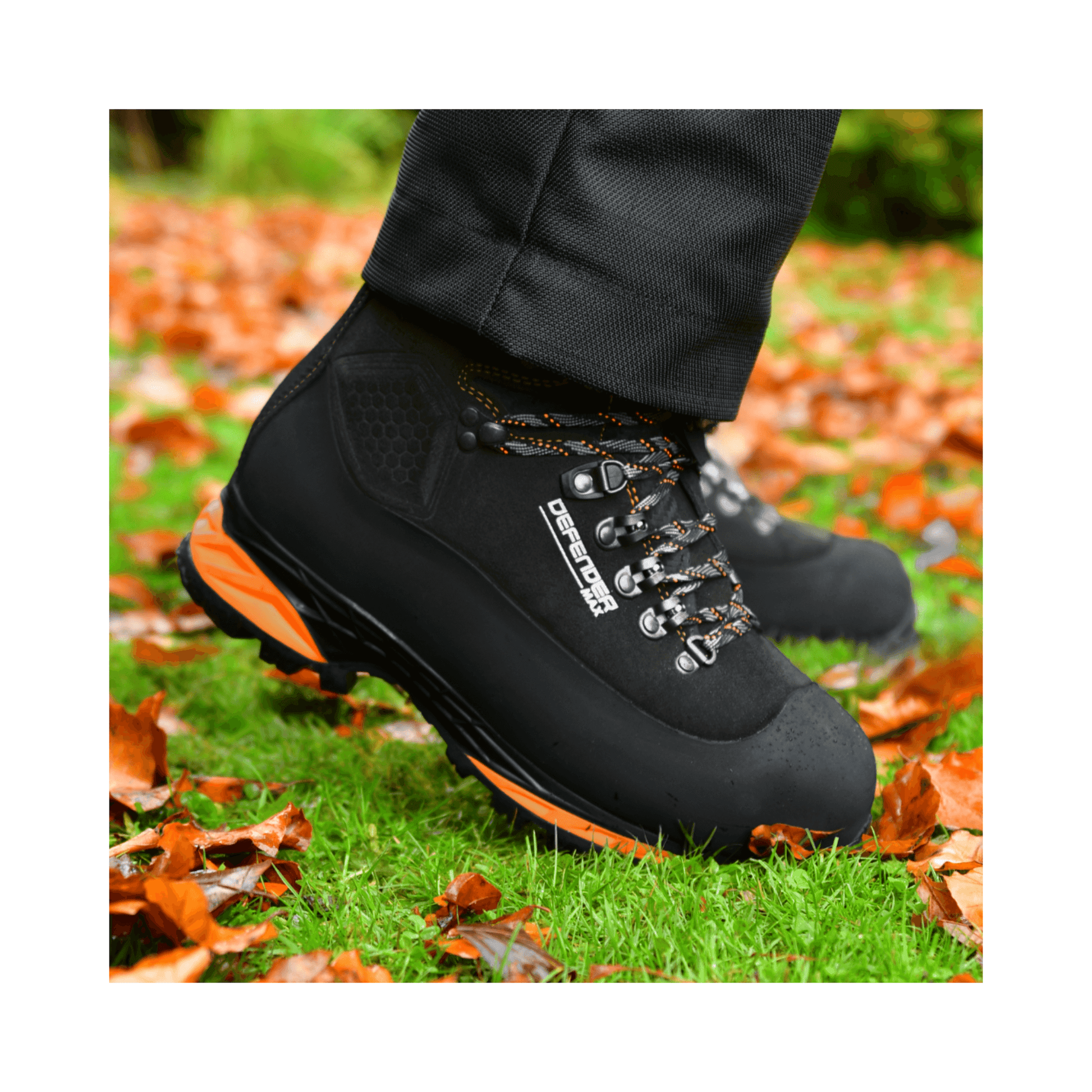 DEFENDER MAX V2 Black Chainsaw Boots Class 2 on a worker's feet in an outdoor setting with autumn leaves.