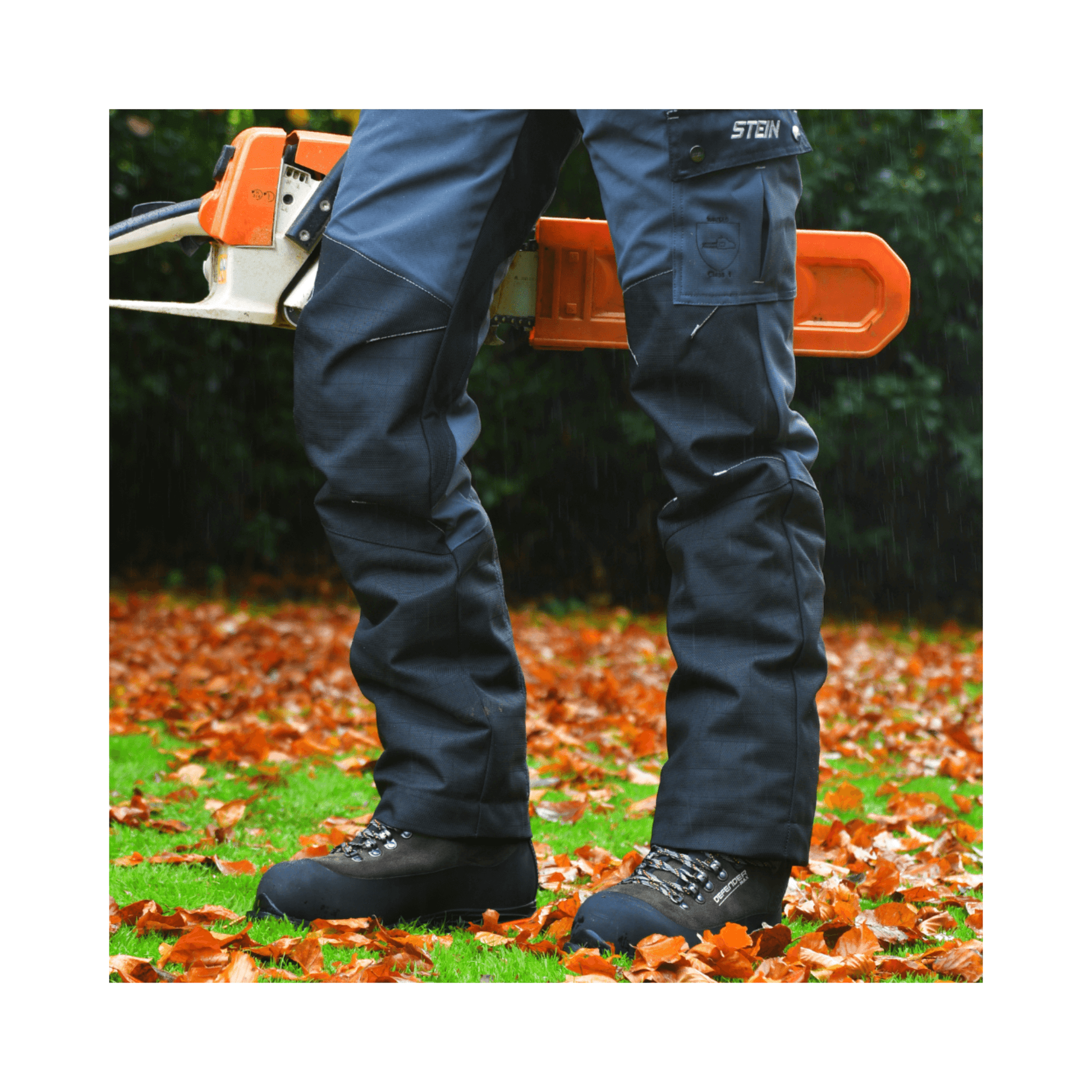 DEFENDER MAX V2 Grey Chainsaw Boots Class 2 worn by a user amidst autumn leaves with a chainsaw in the background.