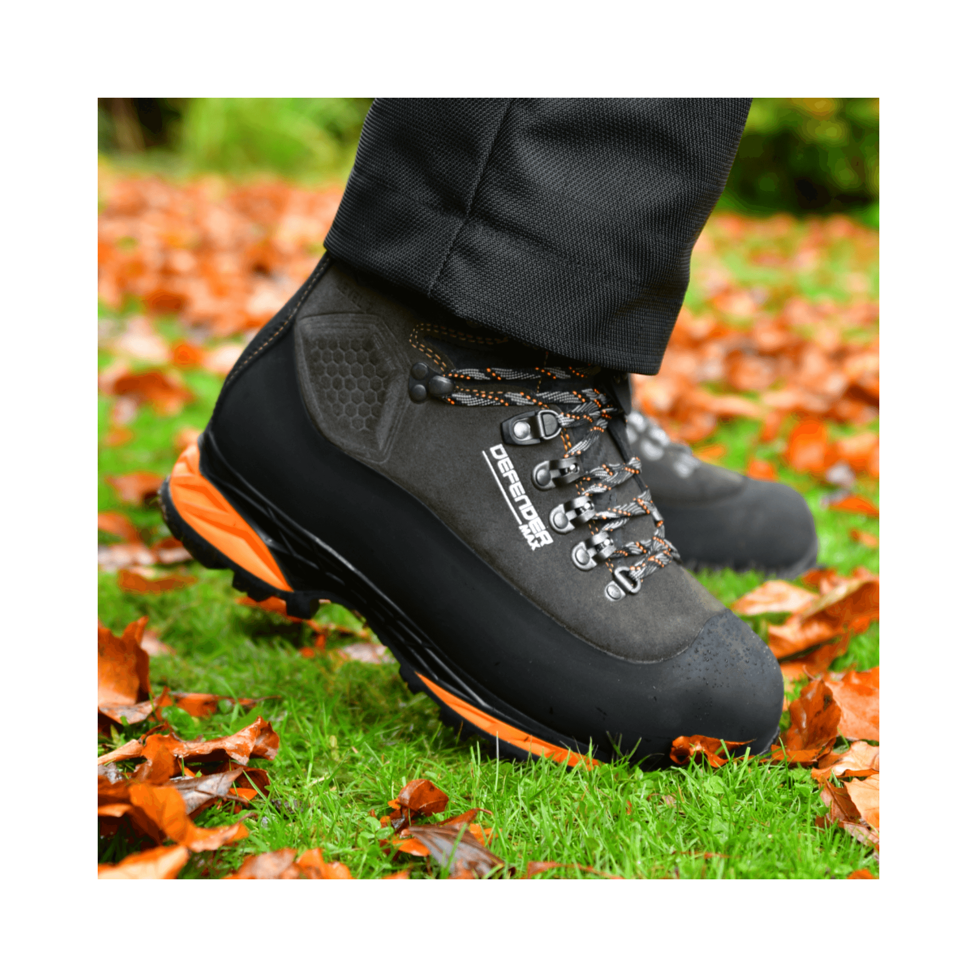DEFENDER MAX V2 Grey Chainsaw Boots Class 2 worn on a grassy surface with fallen leaves.