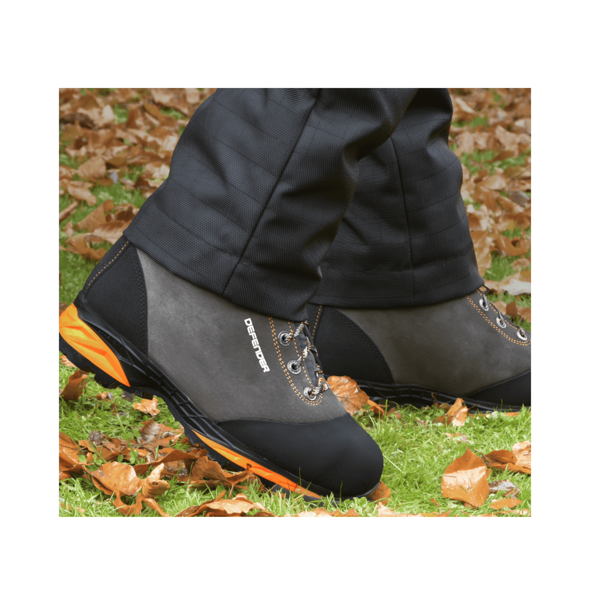 DEFENDER V2 Grey Chainsaw Boots Class 2 worn outdoors on a leaf-covered ground.