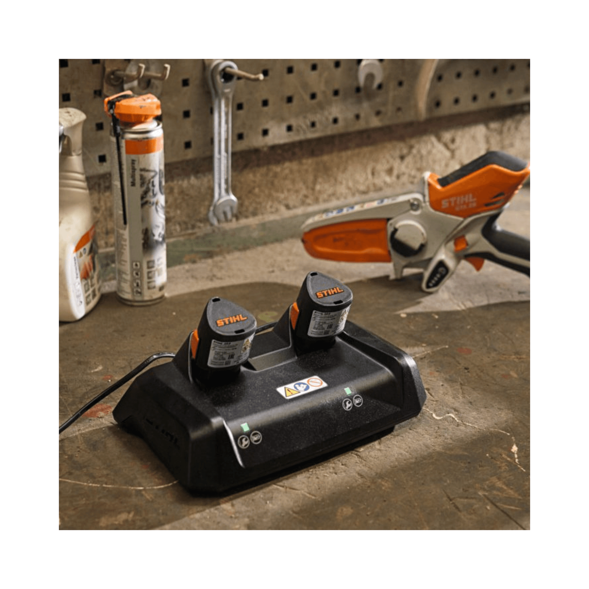 STIHL AL 5-2 Hi-Speed Double AS Battery Charger charging two batteries for tree surgeons in a workshop.