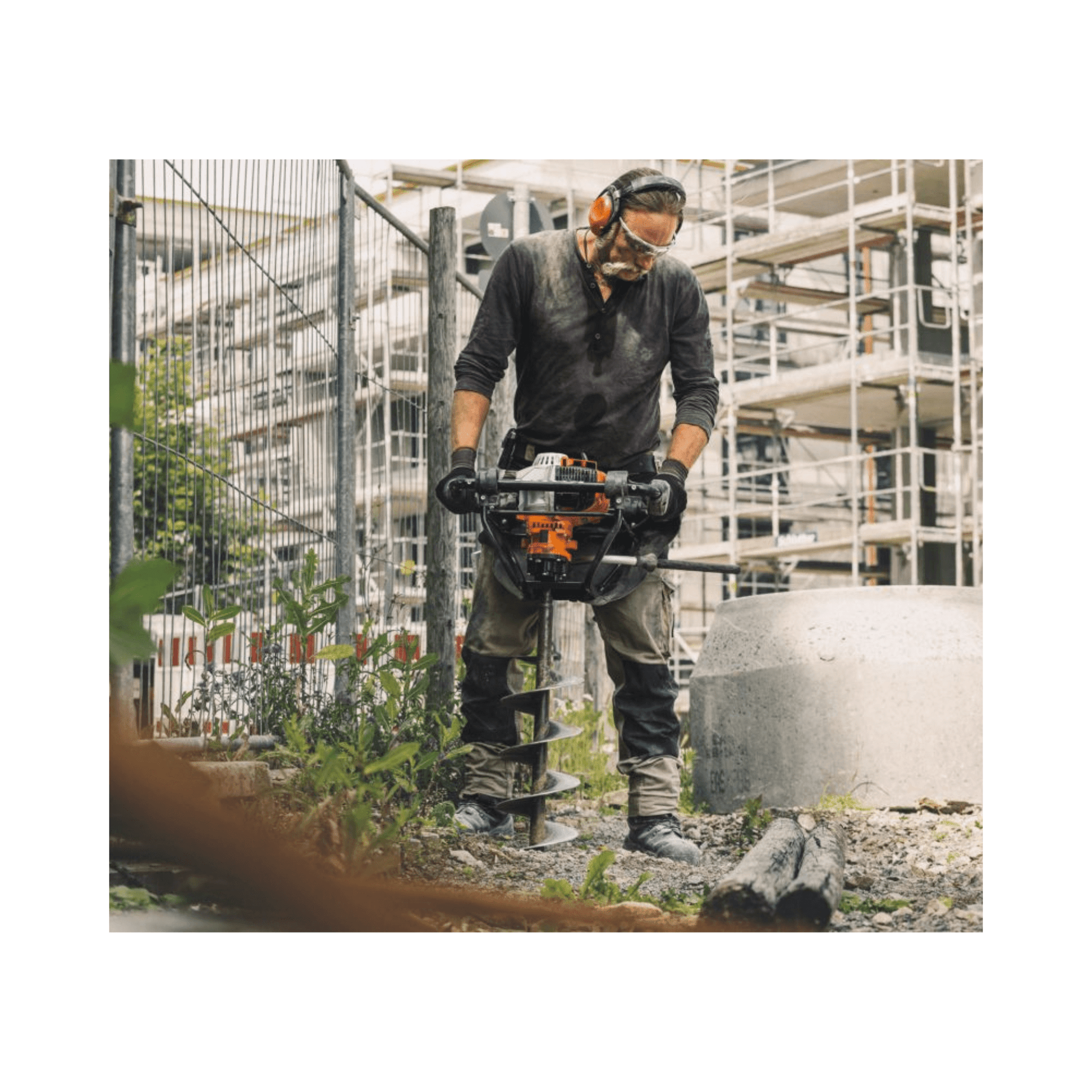 Man operating a STIHL BT 131 Petrol Earth Auger on a construction site.
