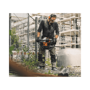 Man operating a STIHL BT 131 Petrol Earth Auger on a construction site.