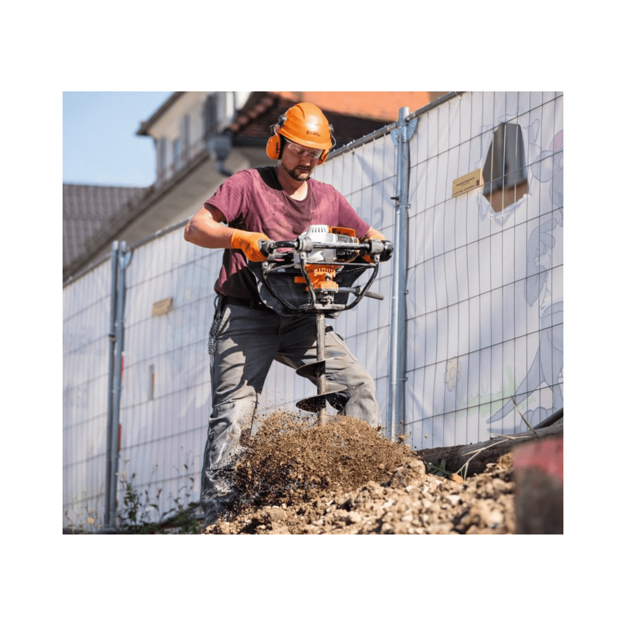 A worker using the BT 131 Petrol Earth Auger to drill into the ground for fence posts or planting.
