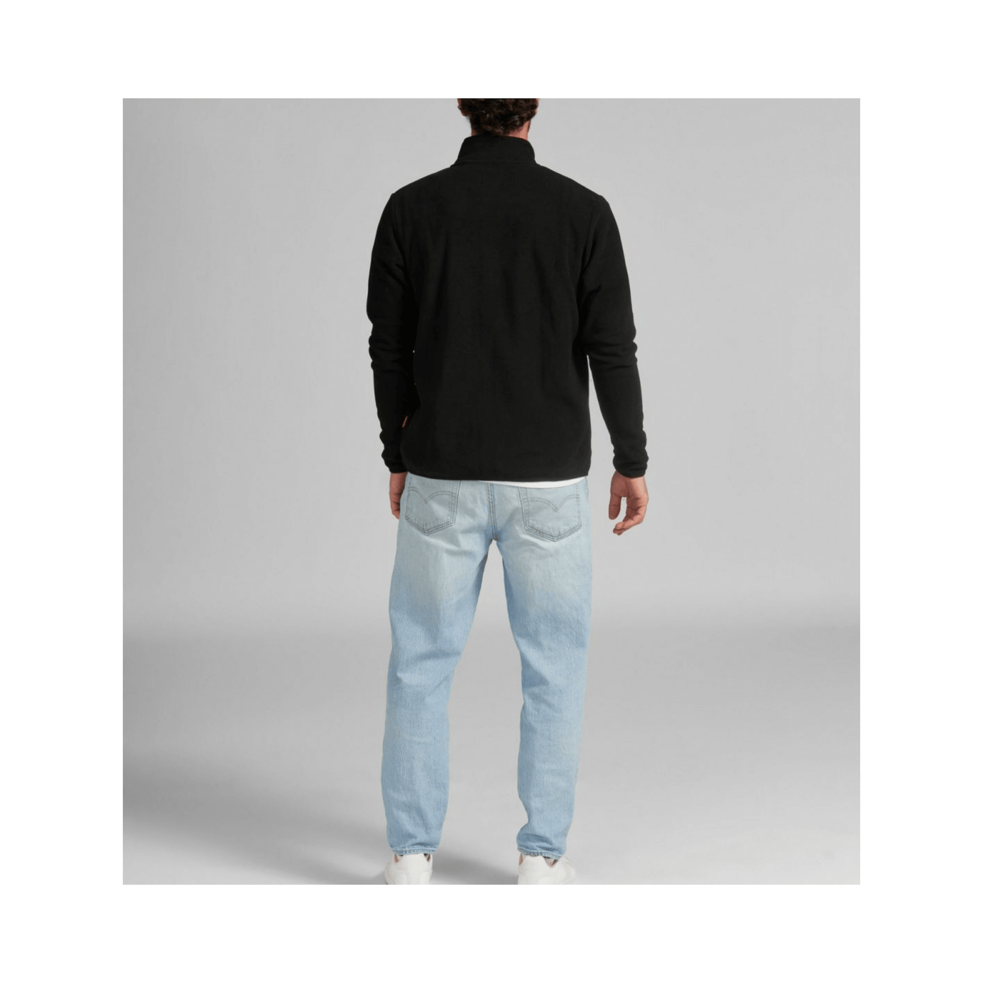 Back view of a man wearing a Black Fleece Jacket, ideal for tree surgeons, providing warmth and comfort.