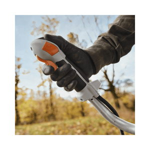 Close-up of gloved hand gripping the STIHL FS 411 C-EM Petrol Clearing Saw handle, designed for tree surgeons.