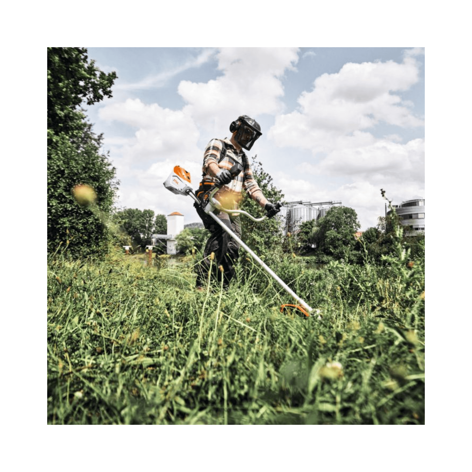 FSA 250 Cordless Brushcutter in use by a tree surgeon in a lush green area.