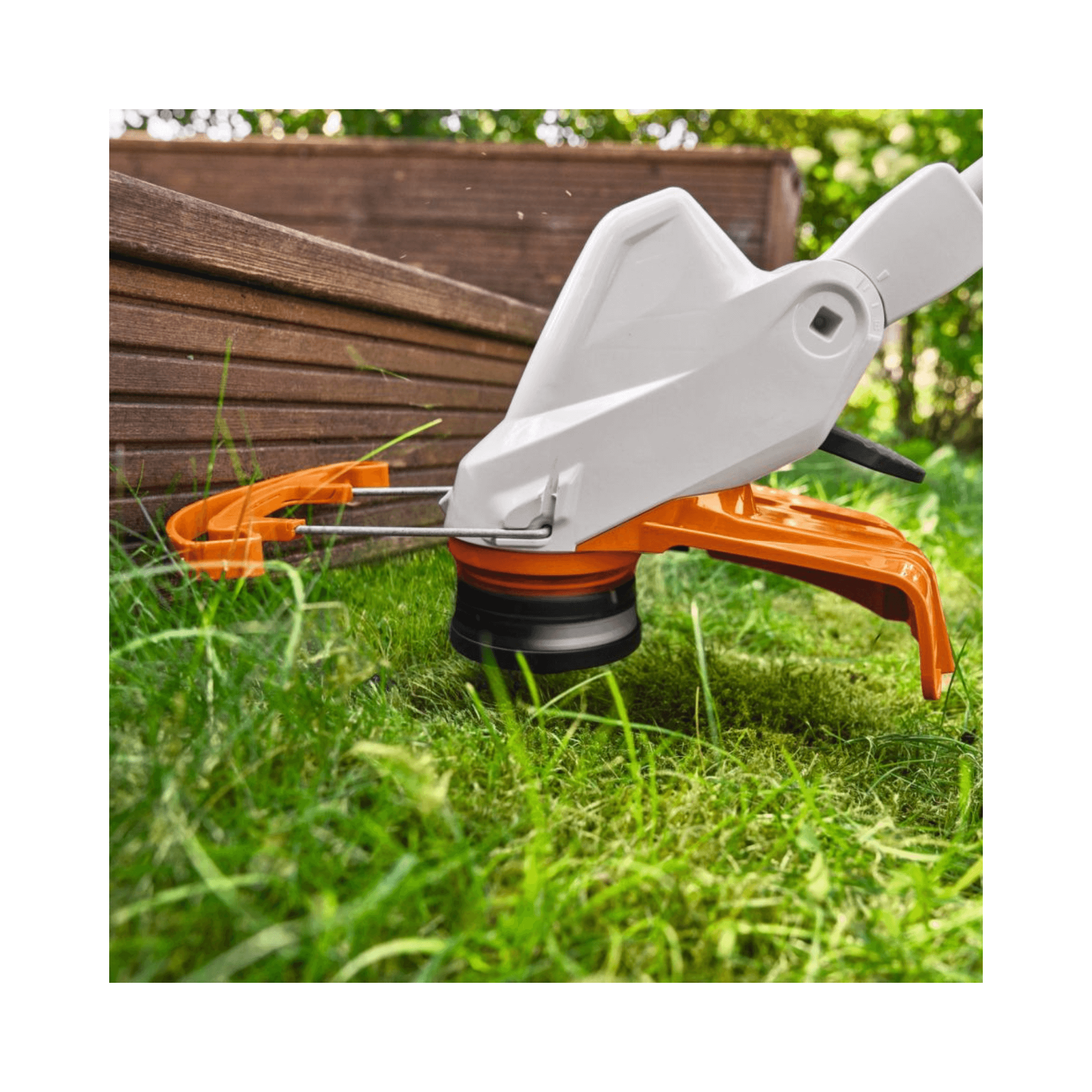 Close-up of the cutting head of the STIHL FSA 57 cordless grass trimmer in action on green grass.