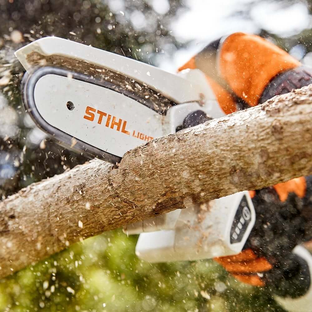 STIHL GTA 26 cordless garden pruner cutting through tree branch, ideal for tree surgeons and precision pruning.