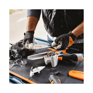 STIHL GTA 26 cordless pruning saw with accessories on a workbench for tree surgery.