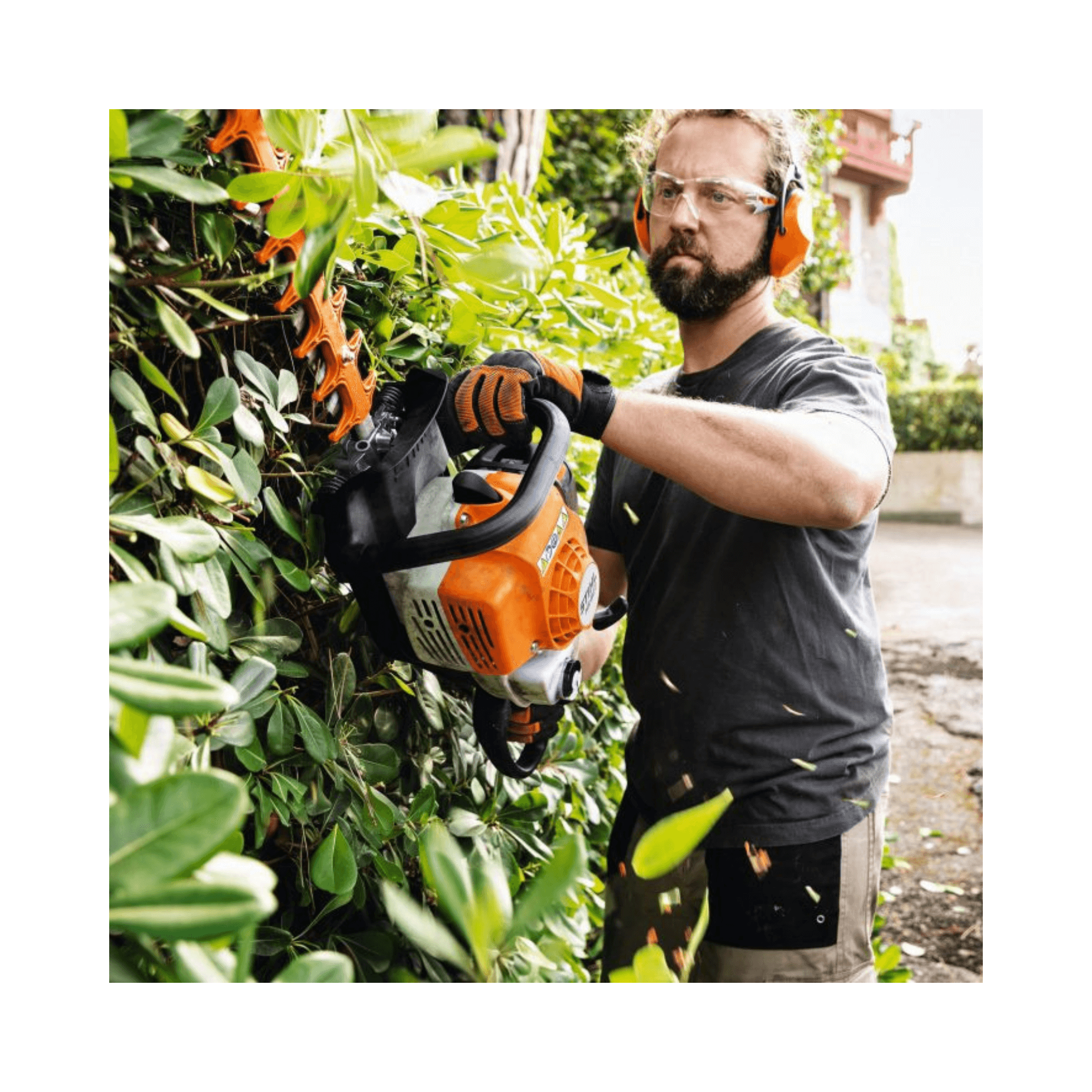 Man using STIHL HS 82 T Professional Petrol Hedge Trimmer for precision pruning in a garden.