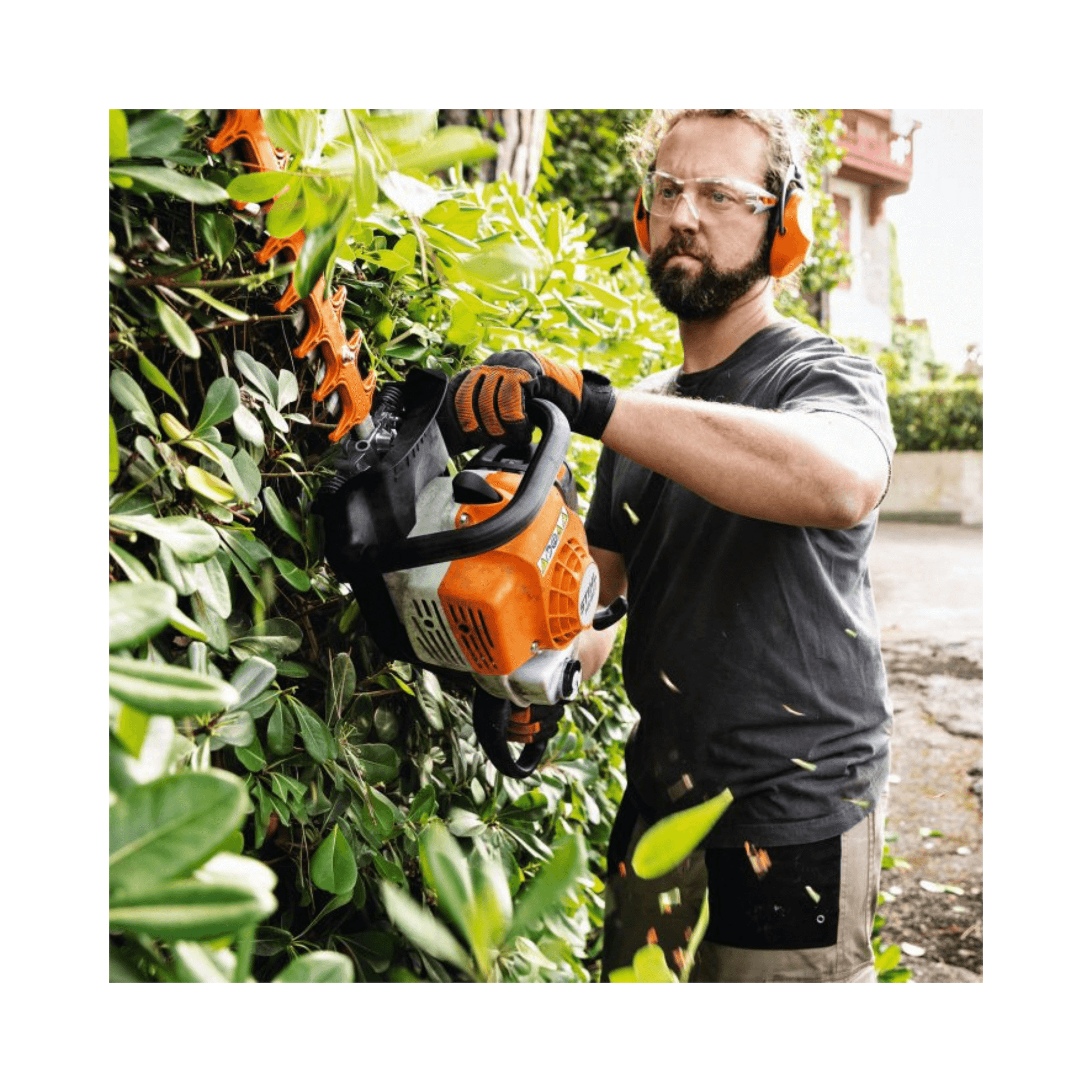 Man using STIHL HS 82 T Professional Petrol Hedge Trimmer for precision pruning in a garden.