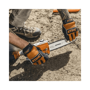 Person wearing STIHL gloves handling a pole pruner on the ground, ideal for tree maintenance professionals.