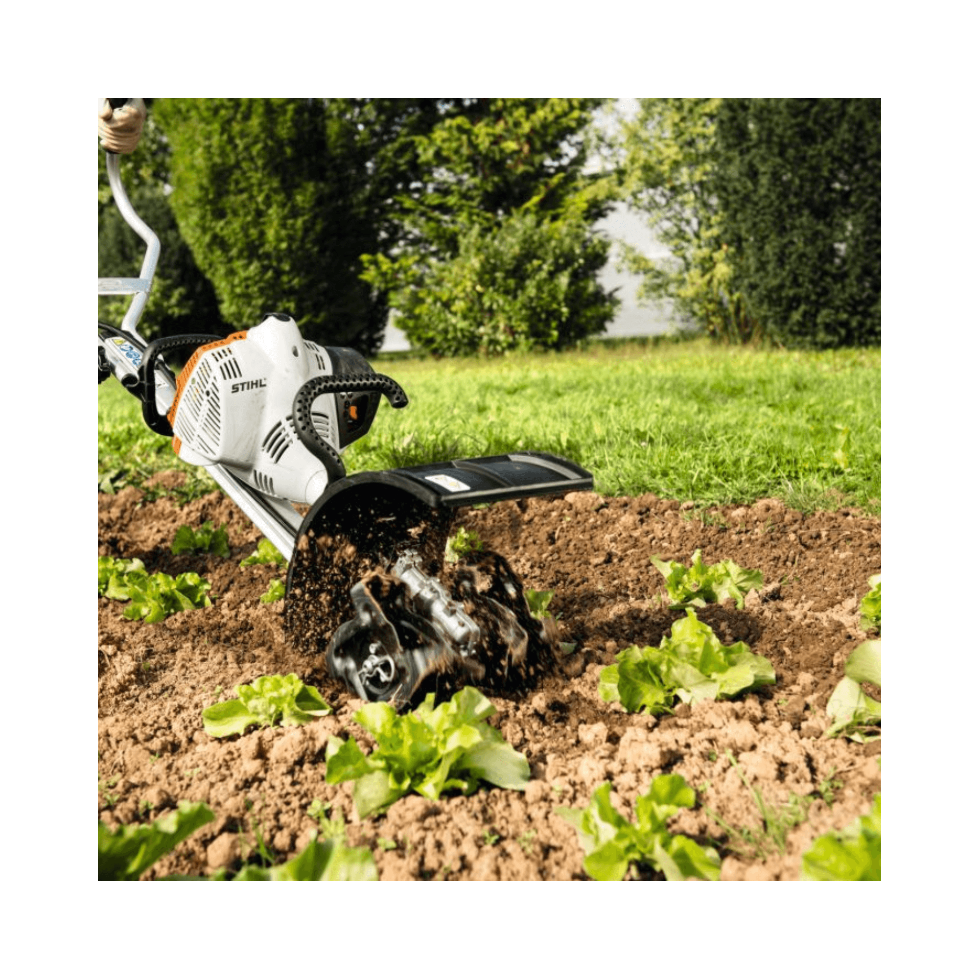 STIHL MM 56 Multi-Tool Engine with Wheel Kit tilling garden soil with attachments.