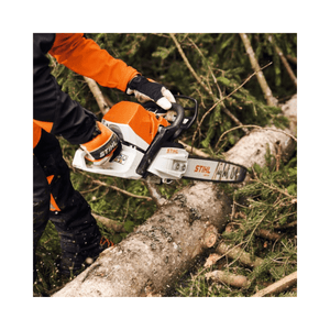 Person using a Stihl chainsaw to cut a log in a forest setting