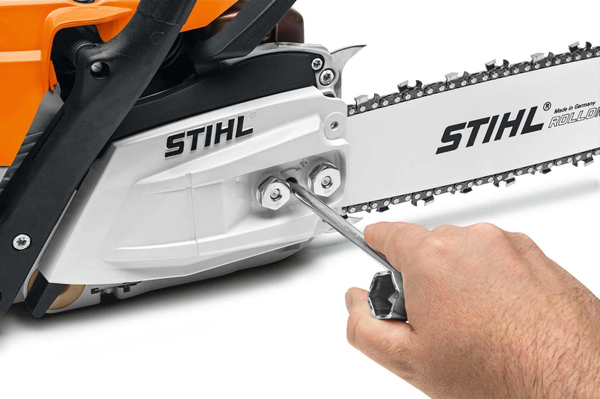 Hand adjusting the chain tension on the STIHL MS 151 TC-E petrol chainsaw, showcasing its user-friendly design.