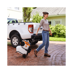 Woman pulling STIHL REA 60-100 trolley with water tank outdoors near a truck, ideal for tree surgeons.
