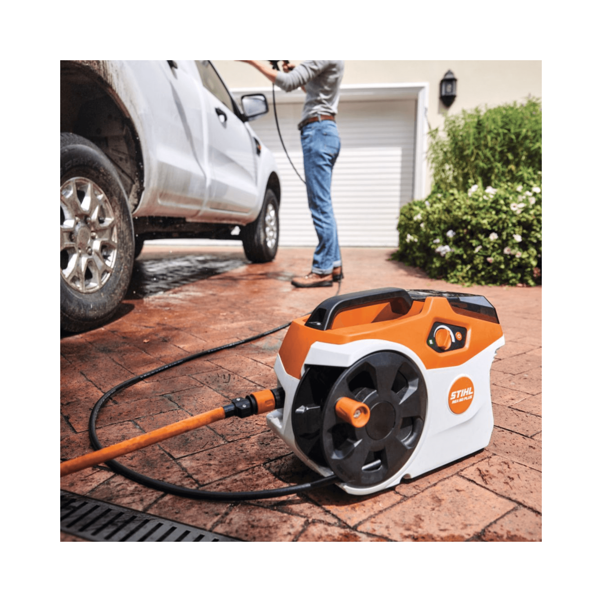 STAHL REA 60 PLUS Cordless Pressure Washer in use for efficient car cleaning with high-pressure hose.