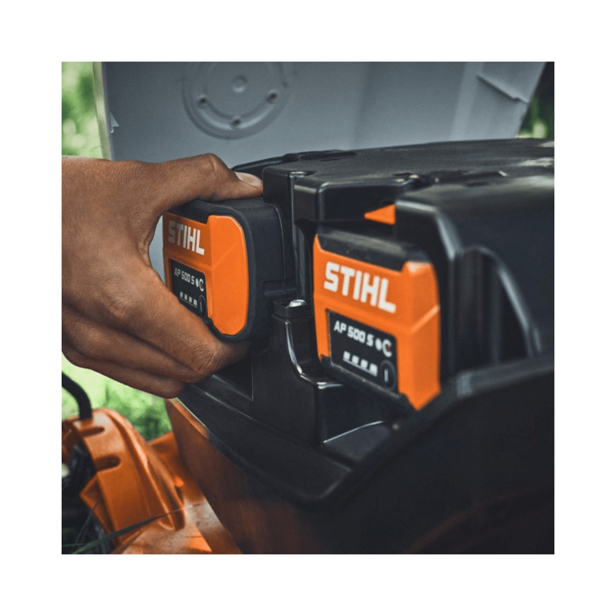RMA 7 RV Professional Cordless Mulching Lawnmower batteries being replaced, showcasing STIHL power system.