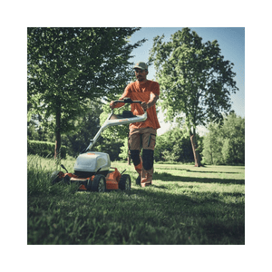 Man using RMA 7 RV Professional Cordless Mulching Lawnmower in a landscaped garden.