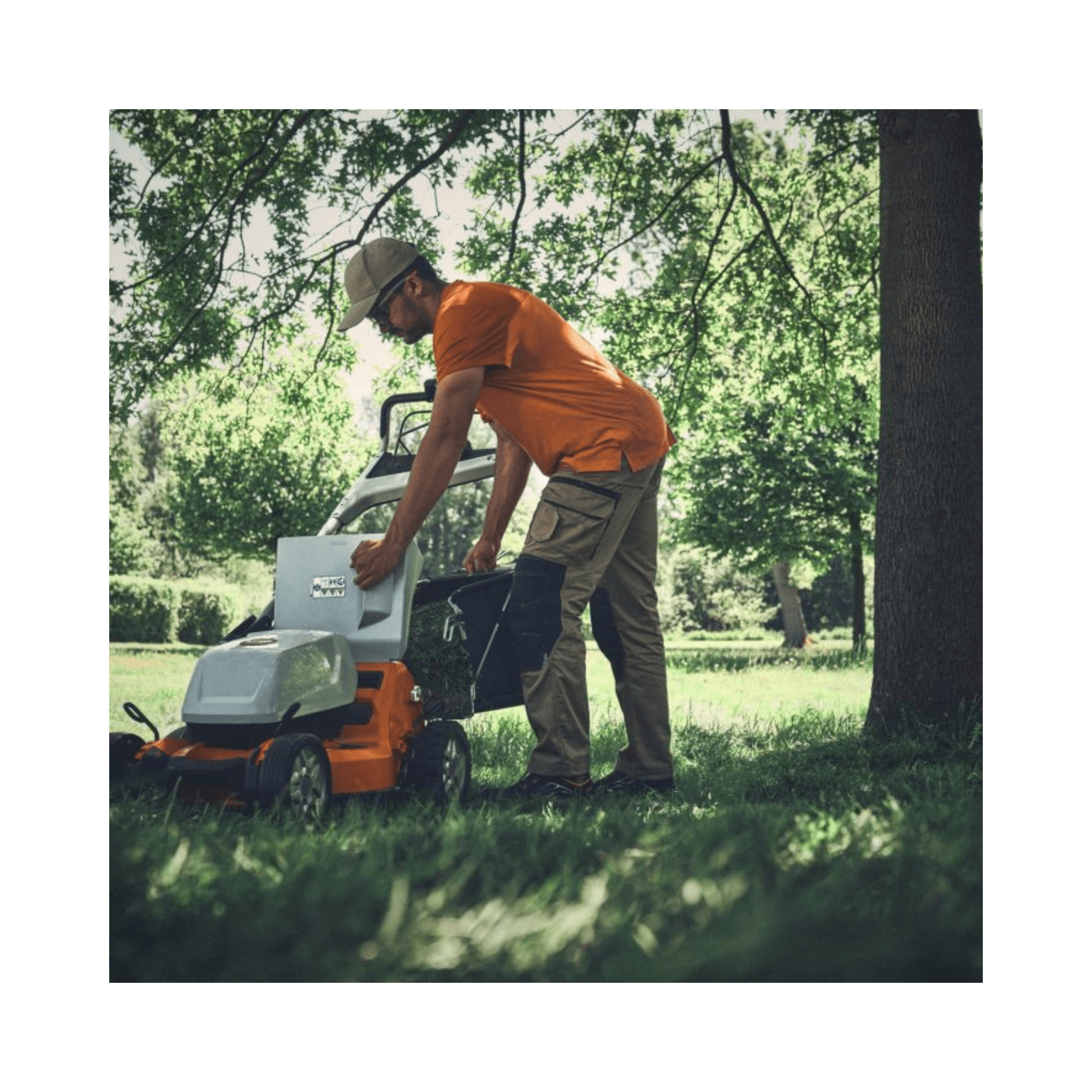 RMA 756V Professional Cordless Lawnmower in use by a professional landscaper in a grassy field.