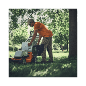 RMA 756V Professional Cordless Lawnmower in use by a professional landscaper in a grassy field.
