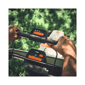 User operating the STIHL RMA 756V Professional Cordless Lawnmower with ergonomic controls.