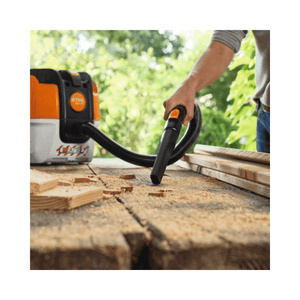 Using the STIHL SEA 50 Cordless Vacuum Cleaner to clean wood shavings on a workbench.