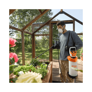 Man using SGA 30 Cordless Backpack Sprayer AS Battery Set in a greenhouse to spray plants.