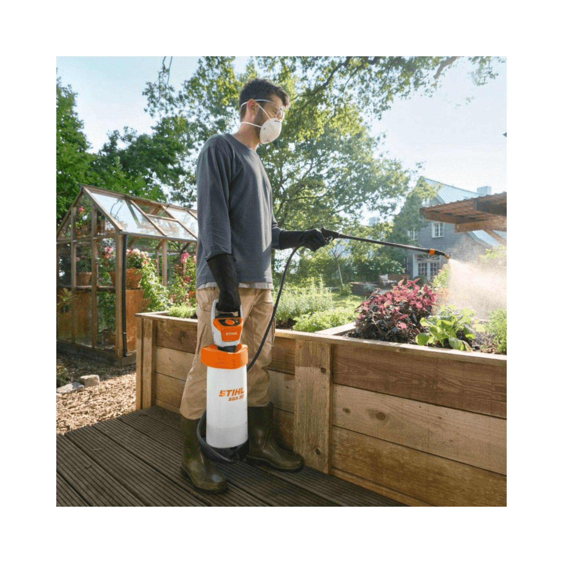 SGA 30 Cordless Backpack Sprayer AS Battery Set in garden, used by man with mask and gloves.