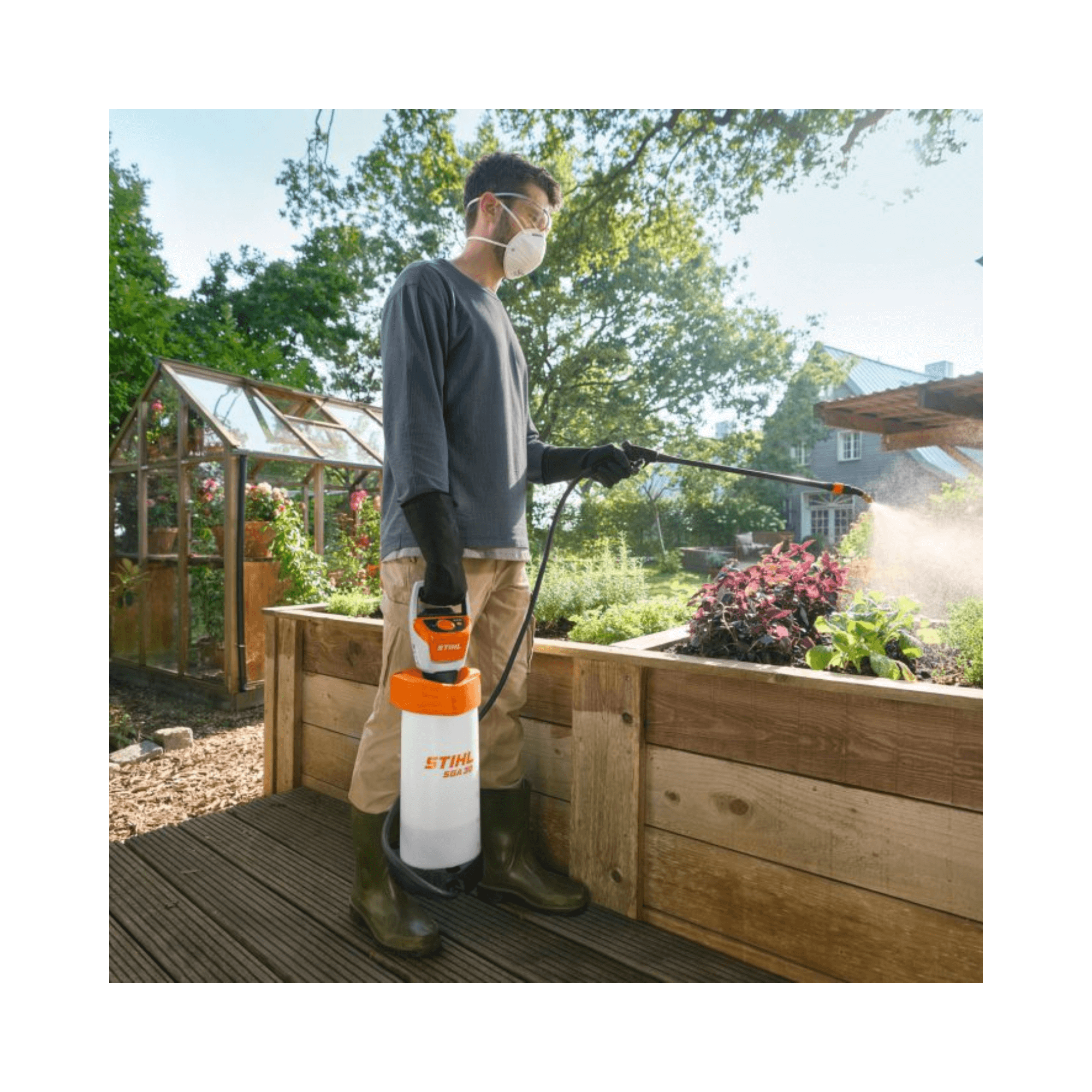 SGA 30 Cordless Backpack Sprayer AS Battery Set in garden, used by man with mask and gloves.
